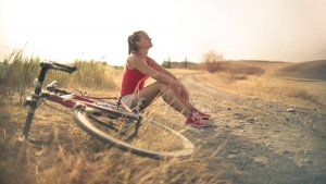 CBD topicals help this athlete relax after a long bike ride. CBD topicals for sale at Synchronicity Hemp Oil